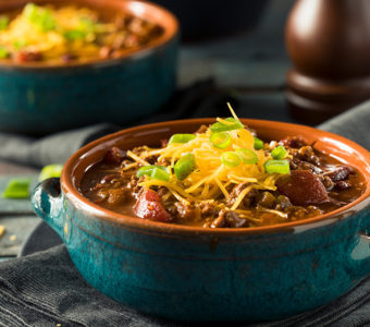 Bowl of chili with shredded cheese on top