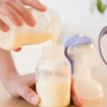 Person pouring breast milk into bottle