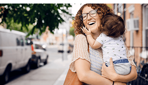 Happy Mom and Baby Walking Downtown