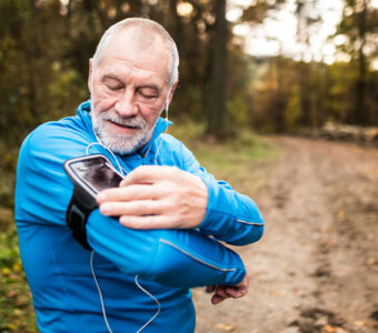 Runner looking at their phone on an armband