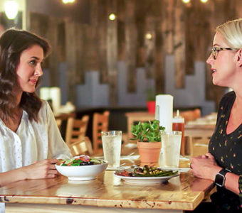 Woman talking to dietitian in restaurant