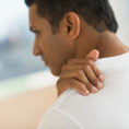 Man holding shoulder in pain