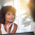 Woman looking at her reflection in a mirror