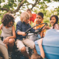 Group of children playing on stationary tractor