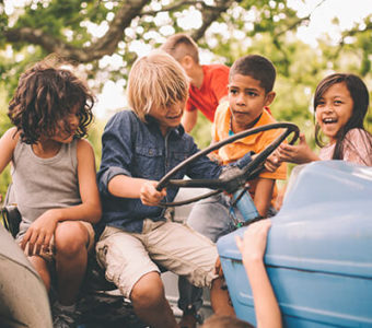 Group of children playing on stationary tractor