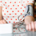 Person taking their blood pressure measurement