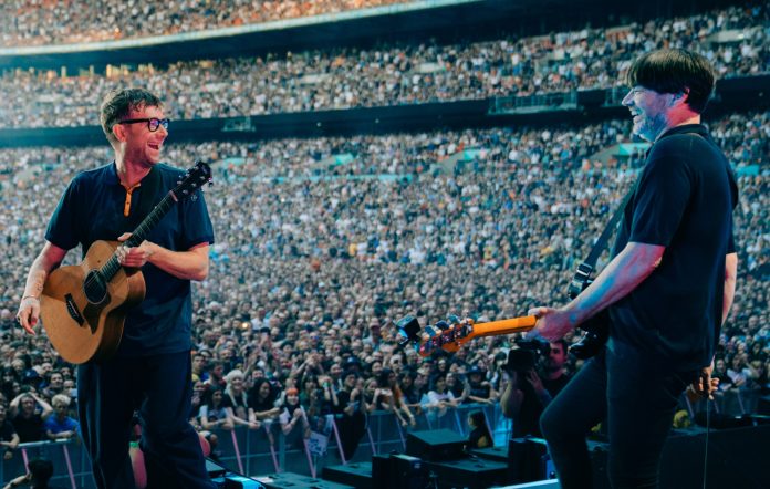 Blur performing live on stage at Wembley Stadium