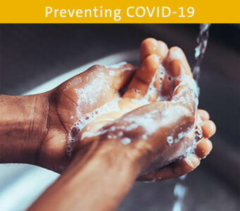 Person washing hands with soap and water