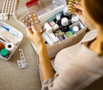 Person putting together a first aid kit