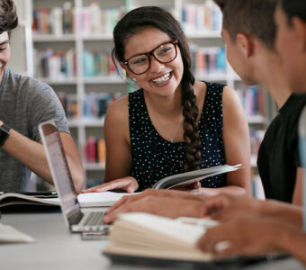 Group of college students studying in library