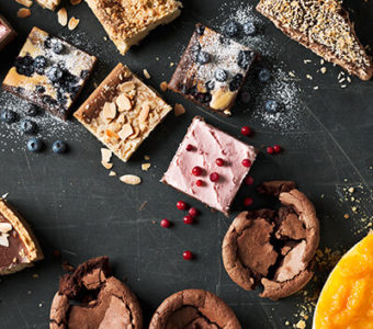 Variety of desserts sitting on a black background