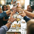 Group of people toasting with glasses at gathering