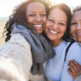 Three generations of women smiling outside