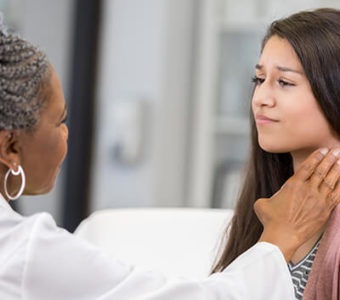 Doctor examining a patient's throat