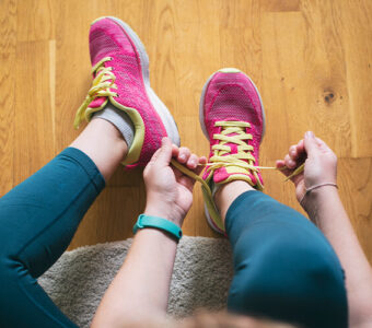 Person tying their running shoes