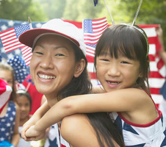 Mother and daughter wearing red, white and blue at a July Fourth celebration parade