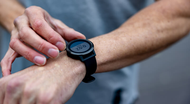 Person checking their running time on a watch