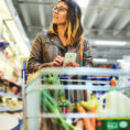 Person grocery shopping with cart