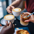 Group of young people drinking coffee together