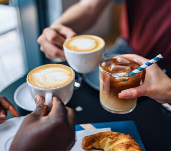 Group of young people drinking coffee together