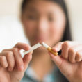 Closeup of hands breaking a cigarette in half