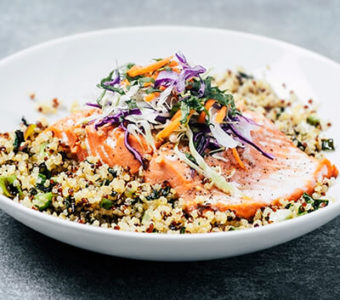 Bowl with grains topped with a filet of salmon