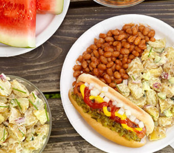 Tabletop with a variety of picnic foods on several plates