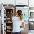 Person organizing refrigerator