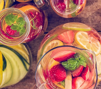 Pitchers and glasses with different flavored teas & infused waters