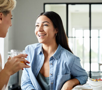 couple siting and talking while eating breakfast