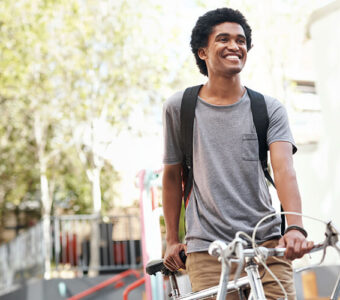 college student mounting bike on way to class