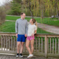 Molly and her partner on a deck with woods in the background