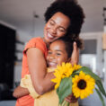 Mother and child hugging and smiling