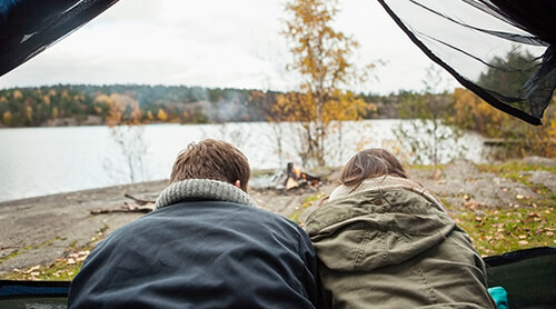 Couple Camping Next to Lake in Fall