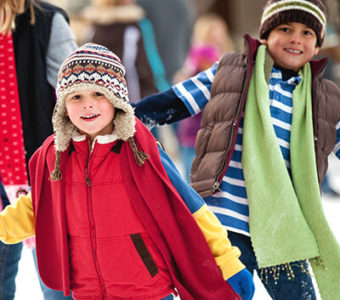 Children ice skating outdoors