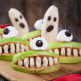 Halloween themed healthy snacks with bananas, apples and peanut butter