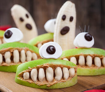 Halloween themed healthy snacks with bananas, apples and peanut butter