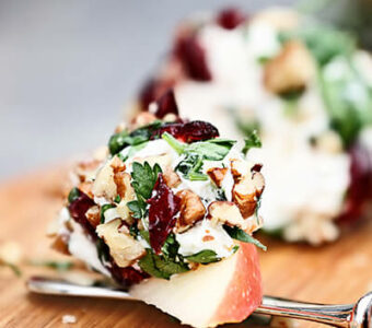 Sliced apples covered with cheese and nuts for appetizer