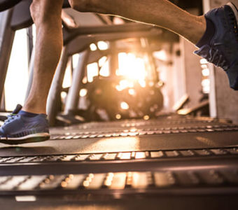 Closeup of a runners on a treadmill in a gym