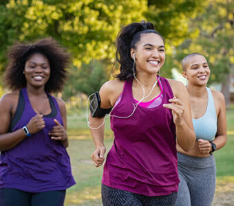 Group of three people running outside