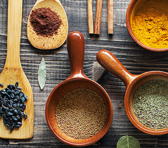 Variety of spoons and containers with different spices in them