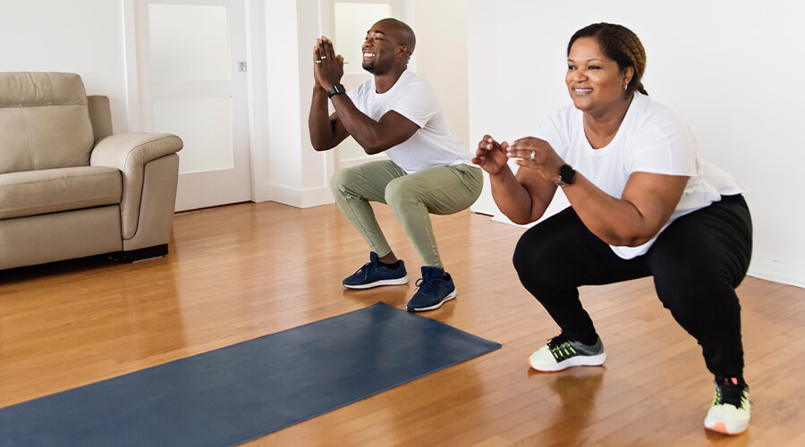 Two people exercising in their home