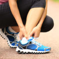 Closeup of person holding ankle bottom of leg in pain