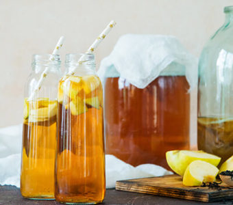 Large jar and small bottles of kombucha tea