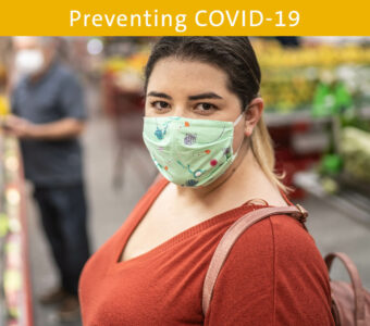 Woman wearing face mask in grocery store while shopping