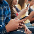 Group of teens texting on their mobile phones