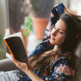 Person relaxing and reading a book