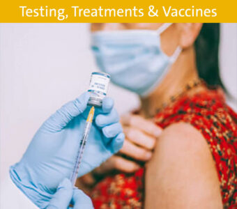 Woman wearing mask receiving the COVID-19 vaccine from a doctor