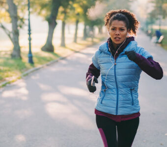 Person running outside in a park in spring weather