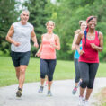 Group of adults running outside on a path